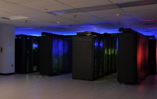 Server racks in a data center with blue and red lighting